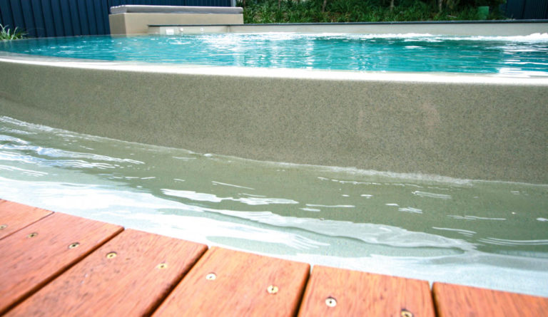 The Horizon fiberglass pool submerged bench and entry steps detail in Diamond Sand