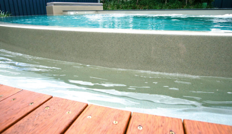 Leisure Pools Horizon disappearing edge swimming pool with built-in bench
