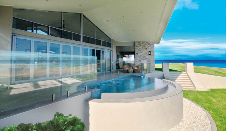Leisure Pools Horizon fiberglass pool in Graphite Grey with backyard installation