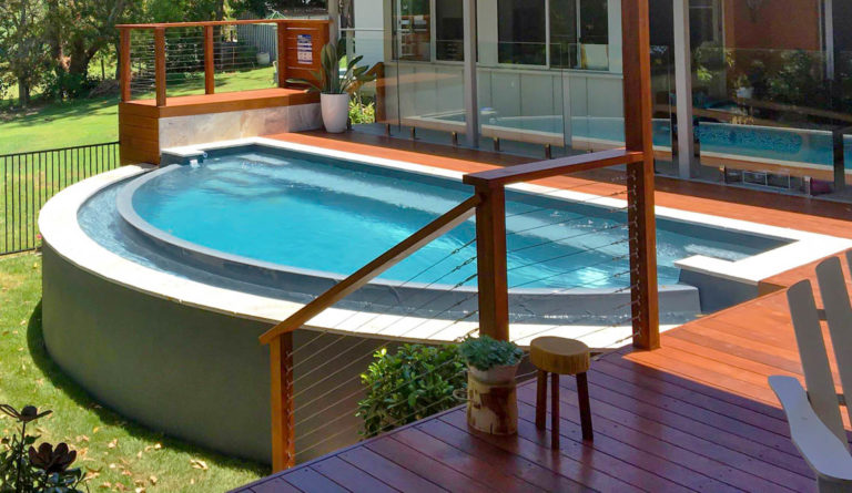 The Horizon fiberglass pool flat bottom design and open swim area in Graphite Grey