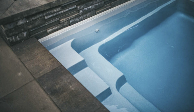 The Reflection fiberglass pool entry steps and full length bench seat underwater detail in Silver Grey