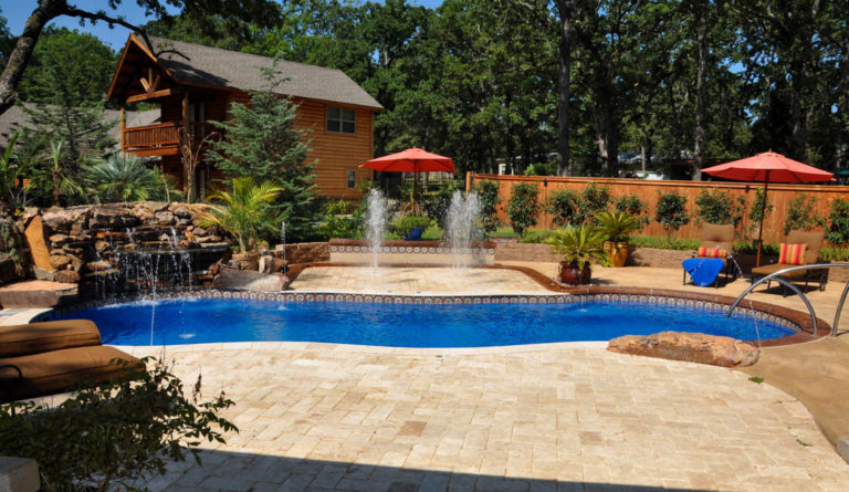 Leisure Pools Riviera fiberglass pool with poolside patio seating area
