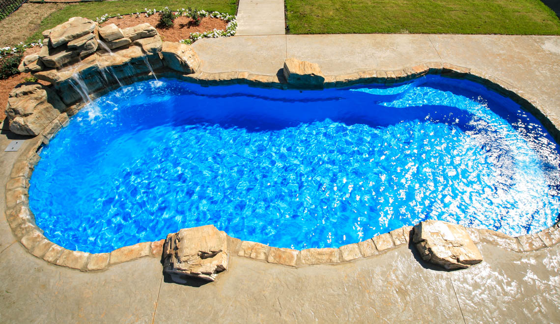 Leisure Pools Riviera composite fiberglass freeform swimming pool with perimeter swimout