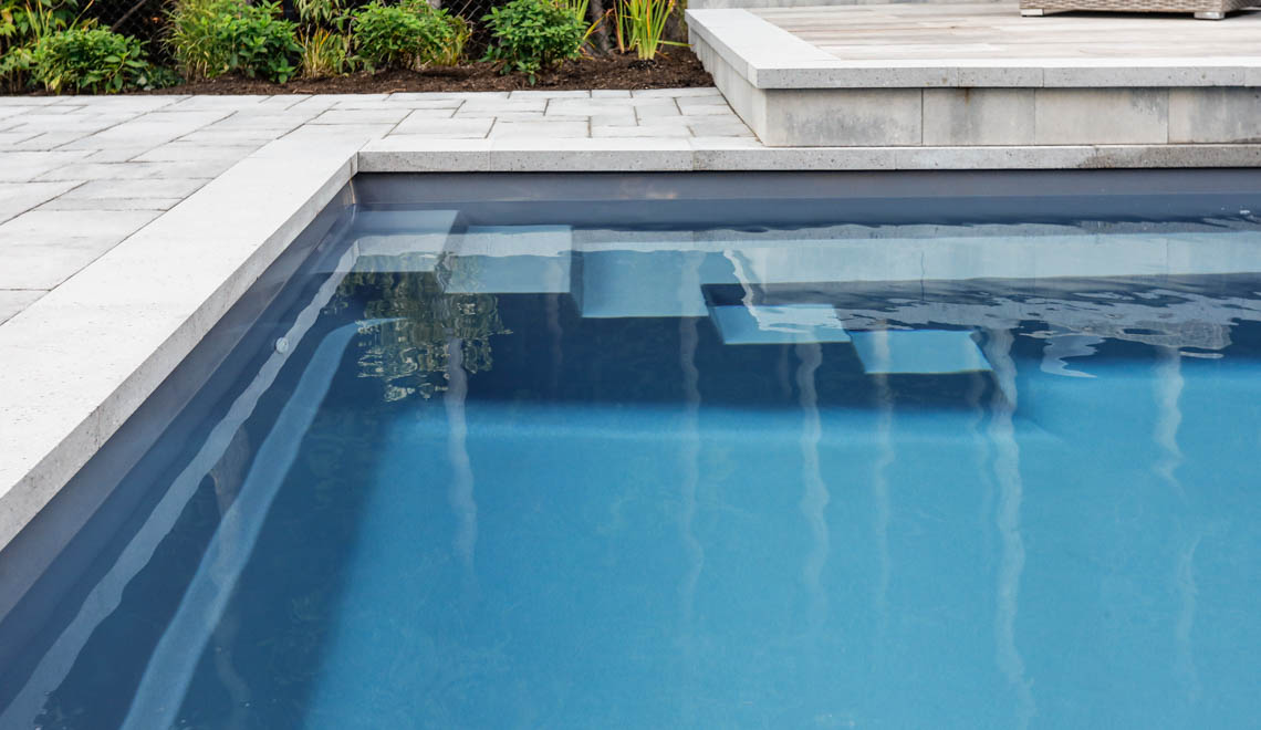 Leisure Pools Supreme composite in-ground swimming pool with deep end swimout and bench seats
