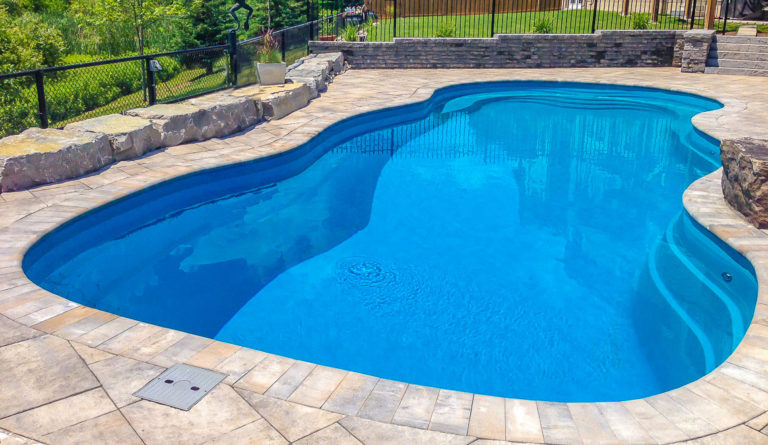 Leisure Pools Caribbean fiberglass pool in Crystal Blue with open swim corridor