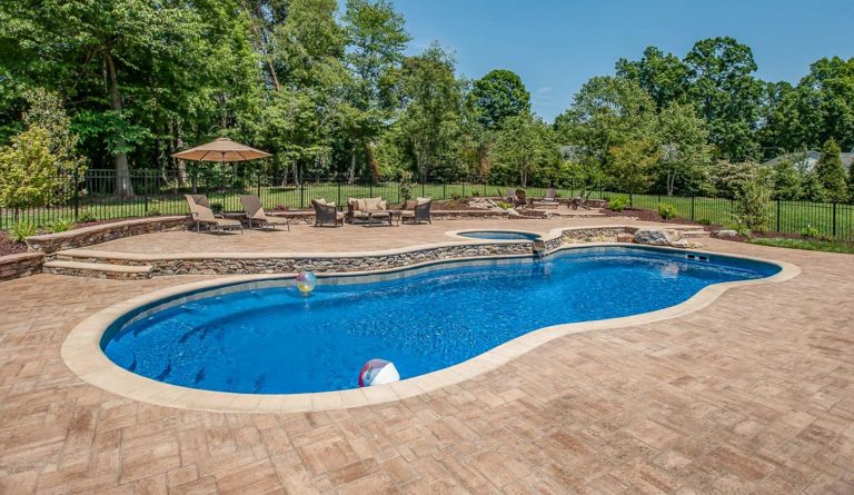 The Caribbean freeform fiberglass pool in Sapphire Blue with large entry steps