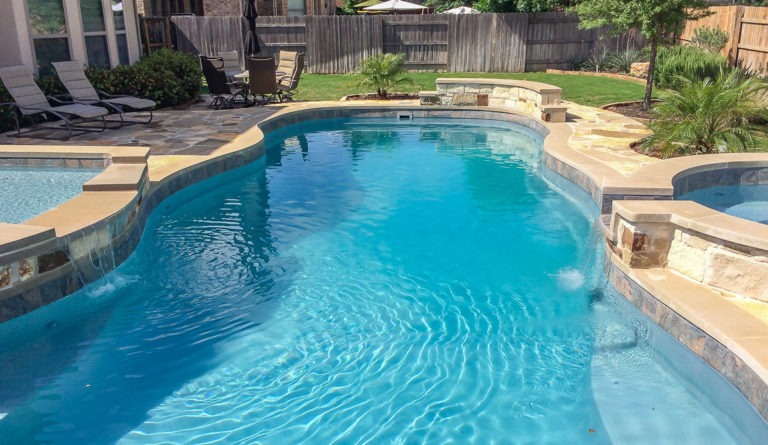 Leisure Pools Caribbean fiberglass pool in Silver Grey with backyard patio surround