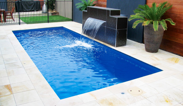 Leisure Pools Palladium Plunge fiberglass pool with spillover water feature in Sapphire Blue