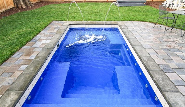 The Palladium Plunge fiberglass pool flat bottom and full pool length view in Sapphire Blue