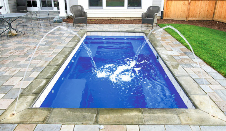 The Palladium Plunge inground fiberglass pool with fountain jet and open patio surround in Sapphire Blue
