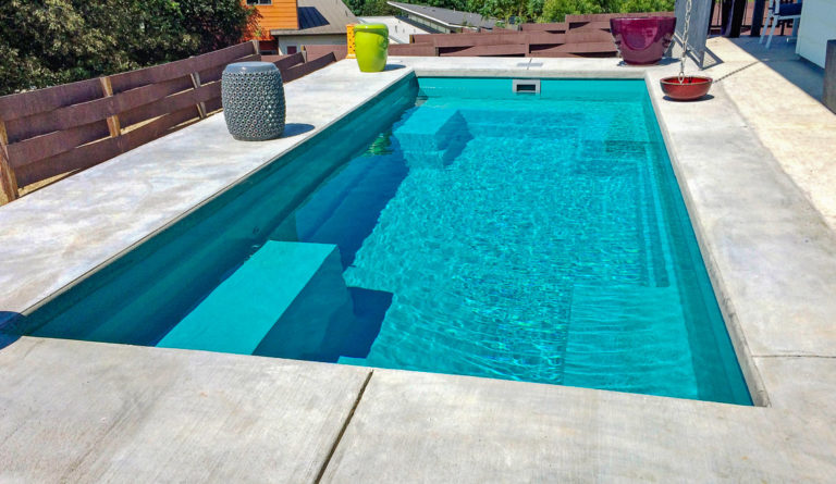 Leisure Pools Palladium Plunge fiberglass pool ample lounge seating ledge detail in Crystal Blue