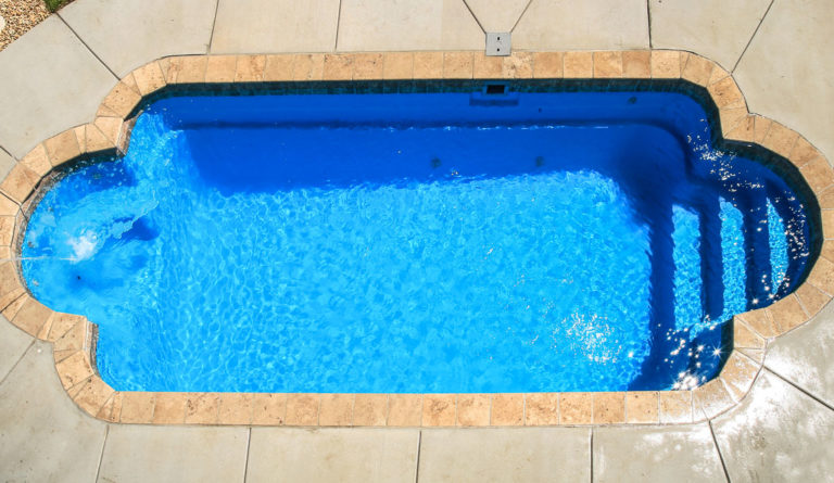 The Roman fiberglass pool spacious entry and exit steps detail in Sapphire Blue