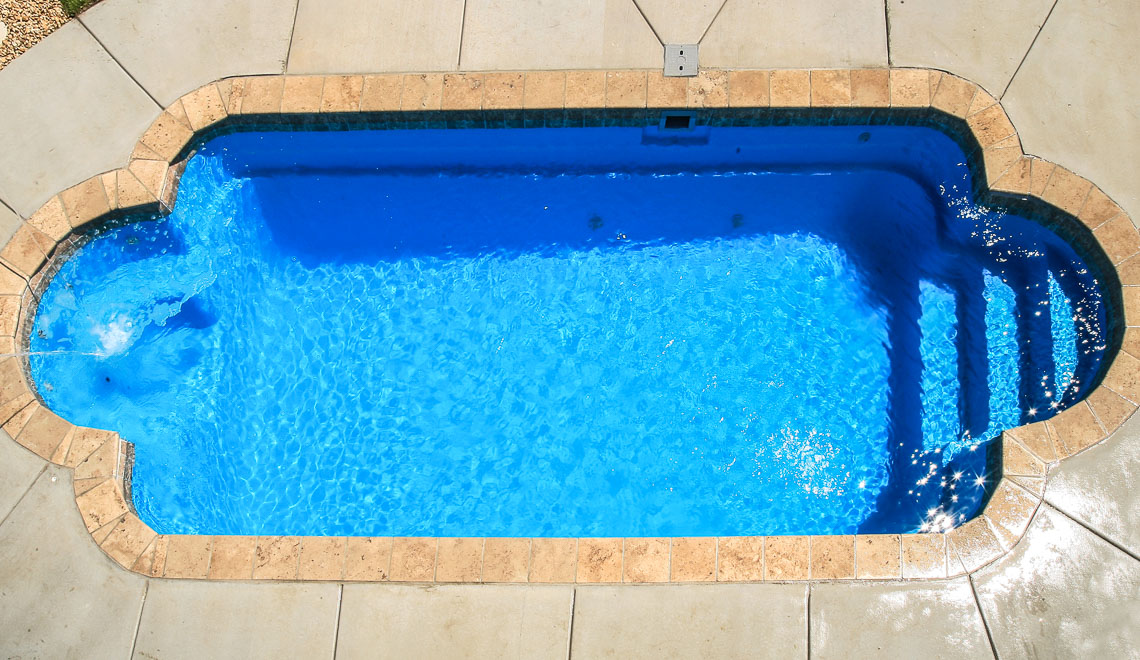 Leisure Pools Roman composite fiberglass swimming pool with perimeter swimout