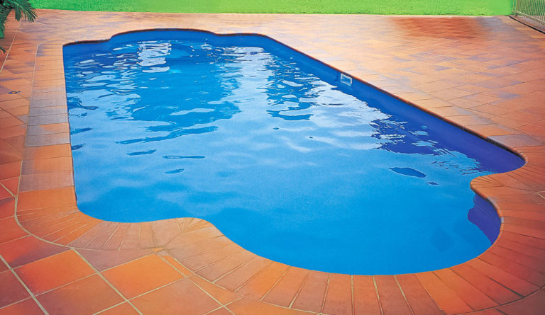 The Roman fiberglass pool in Sapphire Blue showing his and hers bench seating and rounded ends