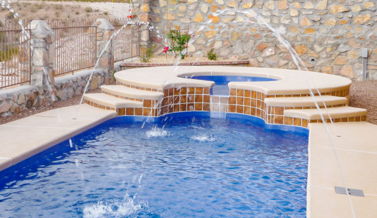 The Roman fiberglass pool in Crystal Blue with waterfall water feature and tile surround