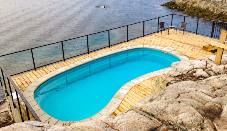 Leisure Pools Tuscany fiberglass pool installed on waterfront lot in Crystal Blue