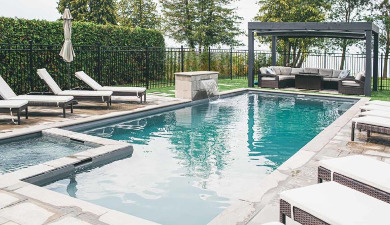 Leisure Pools Ultimate fiberglass swimming pool with built-in spa and tanning ledge