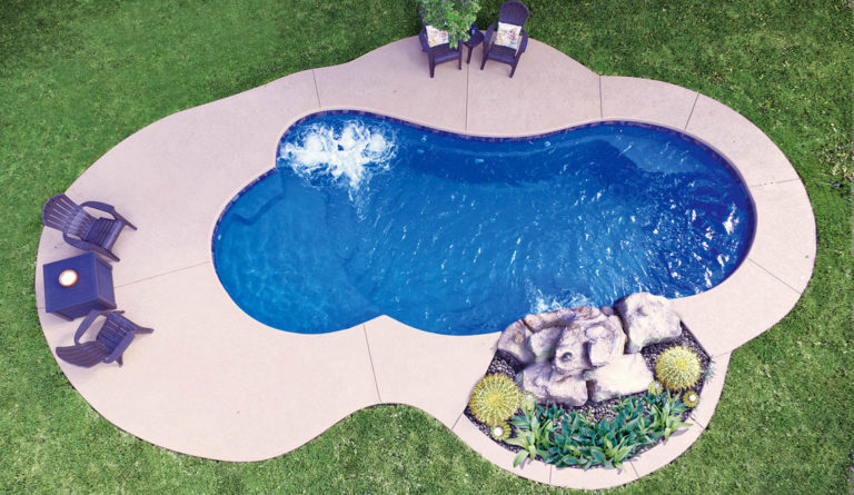 Leisure Pools Eclipse fiberglass pool aerial view with rock landscaping and freeform shape in Sapphire Blue