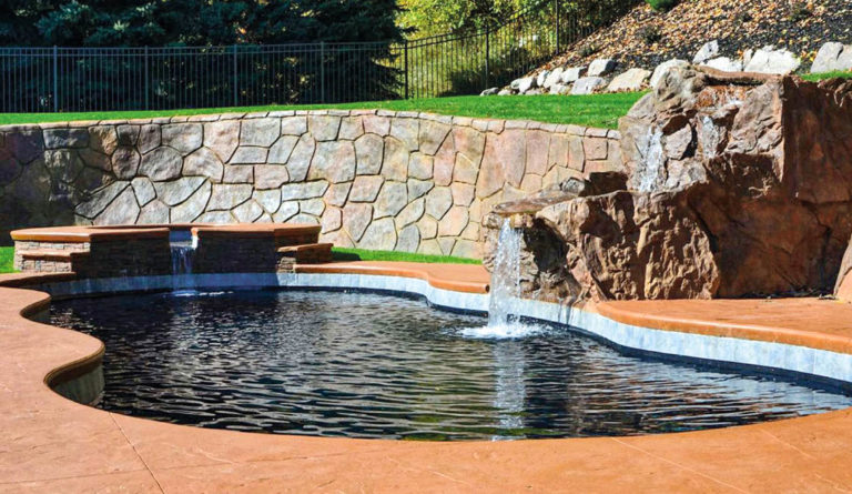 Leisure Pools Mediterranean inground fiberglass pool in Ebony Blue with waterfall feature