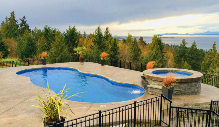 The Mediterranean inground fiberglass pool installed with backyard landscaping in Sapphire Blue