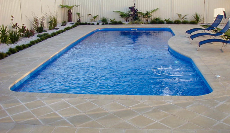 The Moroccan fiberglass pool unobstructed swim channel and clean patio surround in Sapphire Blue