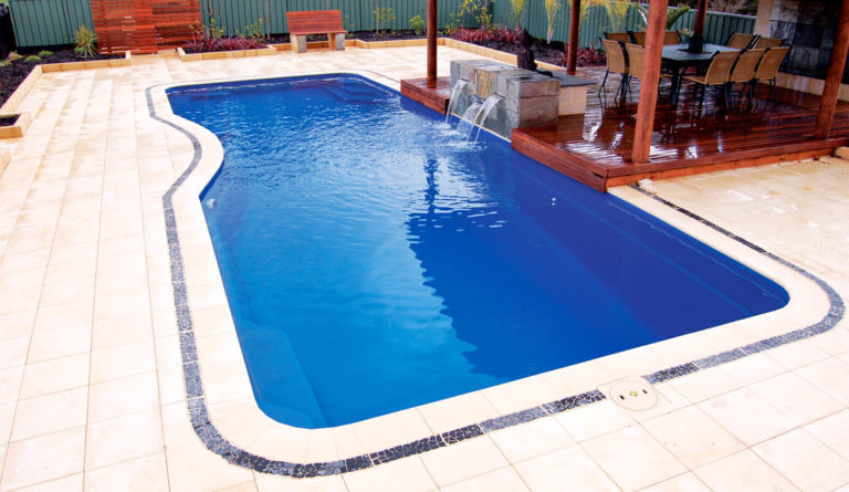 The Moroccan fiberglass pool in Sapphire Blue with covered patio and outdoor seating area