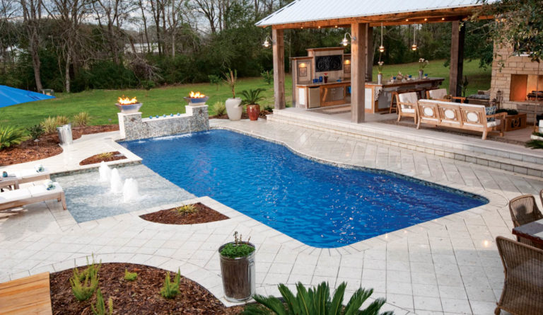 The Moroccan fiberglass pool in Sapphire Blue with covered outdoor kitchen and pergola
