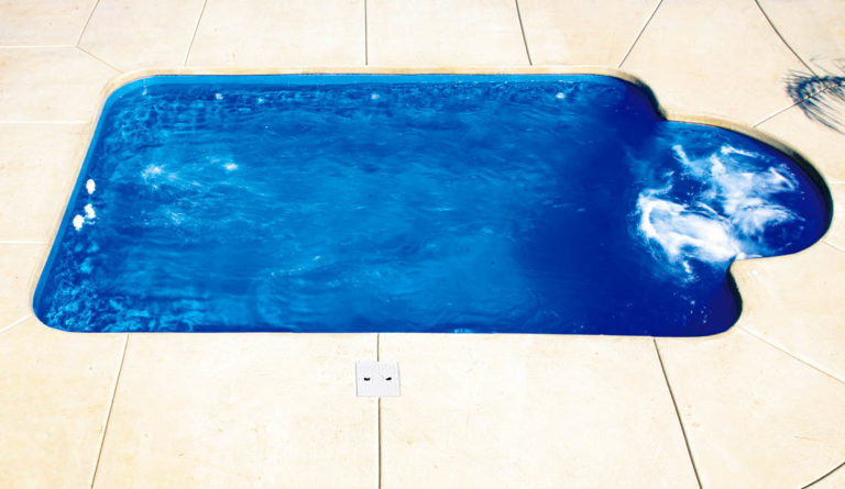 Leisure Pools Courtyard Roman fiberglass pool overhead view showing full keyhole design in Sapphire Blue