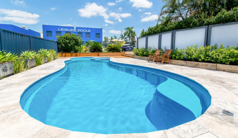 Leisure Pools Allure freeform fiberglass pool in Crystal Blue full backyard installation