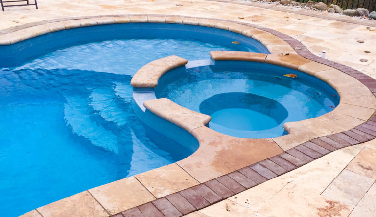 The Allure fiberglass pool integrated splash deck and curved bench seating detail in Sapphire Blue