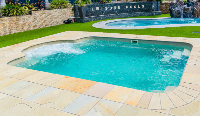 Leisure Pools Courtyard Roman fiberglass pool at dealer display installation