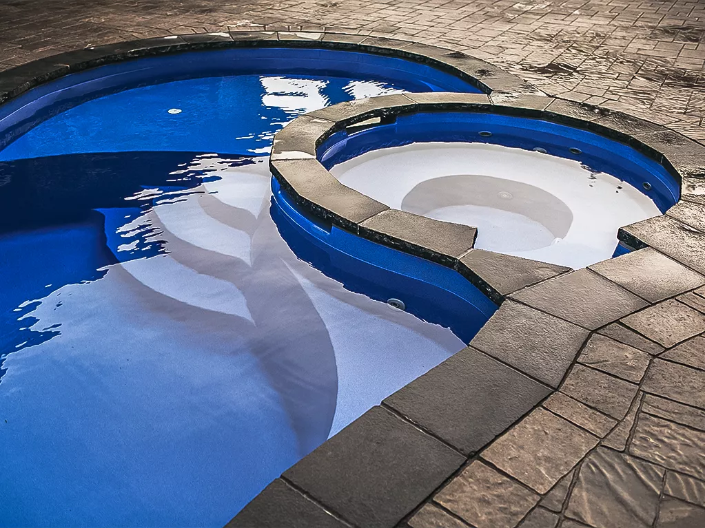 Leisure Pools Allure fiberglass pool with built-in spa