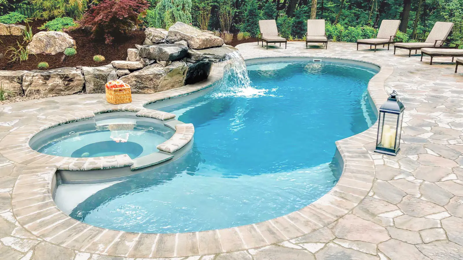 The Allure, a freeform fiberglass pool with a built-in spa in addition to a splash pad