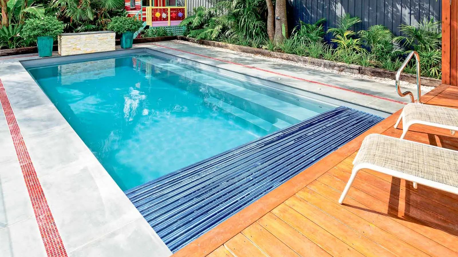 The Reflection plus Cover Box, a fiberglass pool with full-length bench seating and built-in cover box