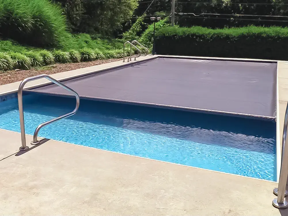 An automatic pool safety cover adds an extra layer of security to your backyard fiberglass pool