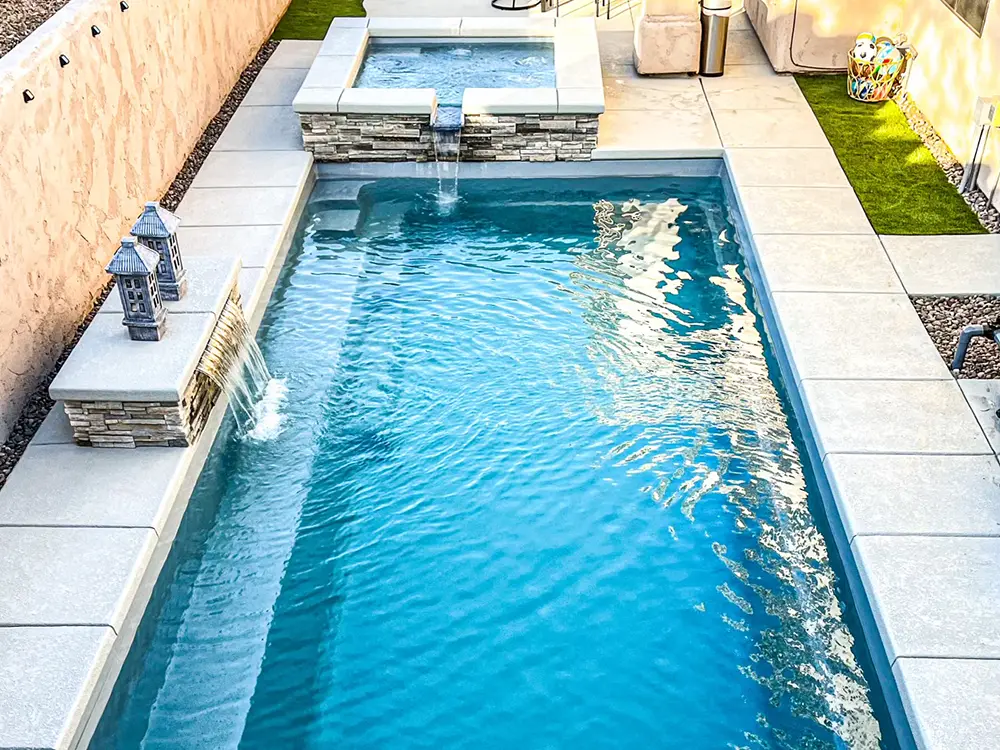 A stunning fiberglass backyard pool that complements this backyard.
