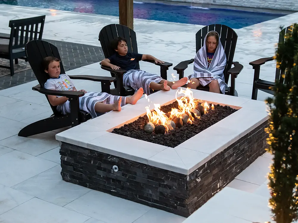 A pool-side fire pit is the ultimate gathering spot. 