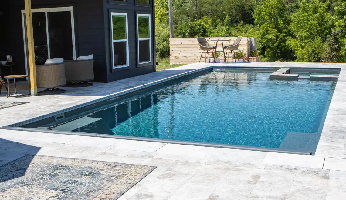Leisure Pools Ultimate fiberglass swimming pool with built-in spa and splash deck in Graphite Grey