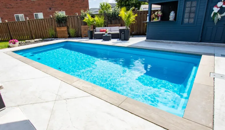Leisure Pools Reflection fiberglass pool in Crystal Blue with contemporary urban backyard setting