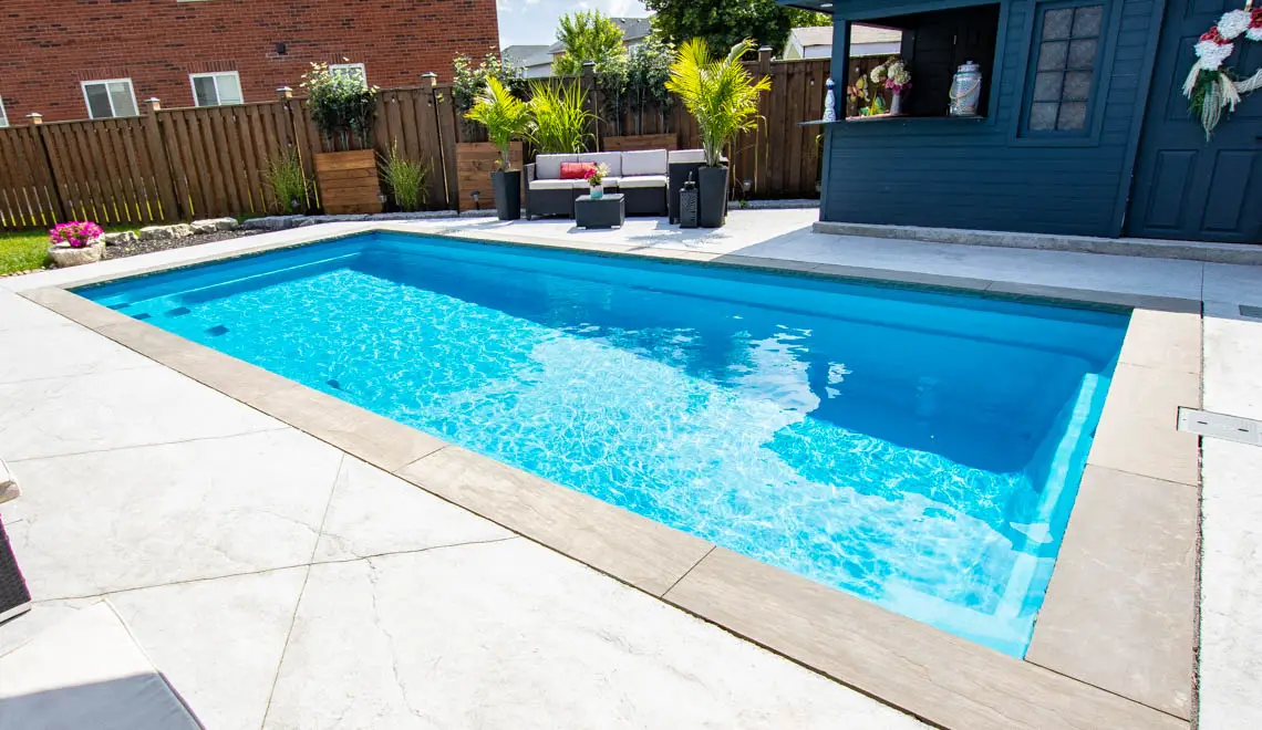 Leisure Pools Reflection inground fiberglass swimming pool with entry steps in Crystal Blue