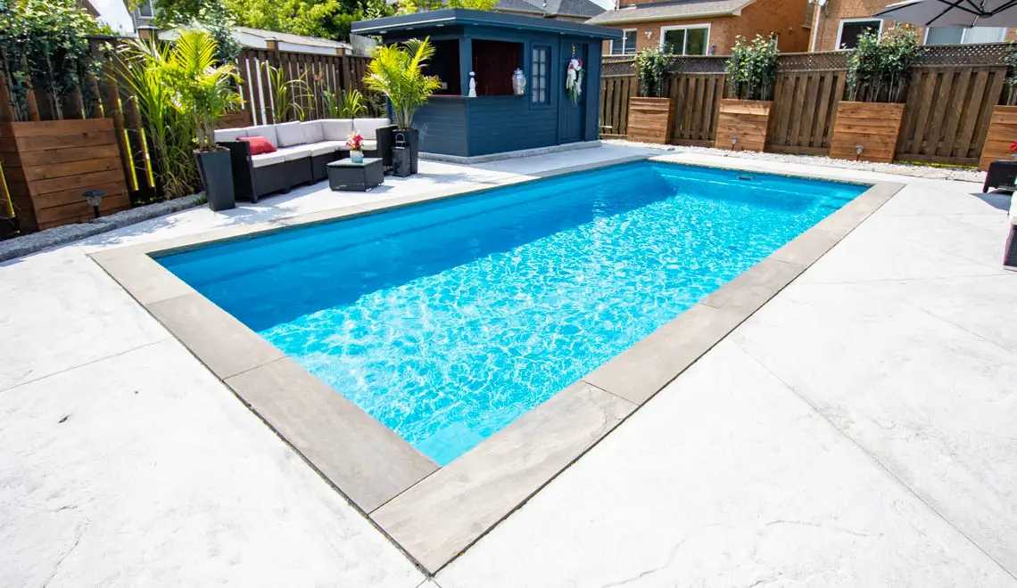 Leisure Pools Reflection inground fiberglass swimming pool with bench seat in Crystal Blue