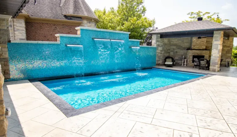 The Supreme 40 fiberglass pool with raised wall water feature in Crystal Blue