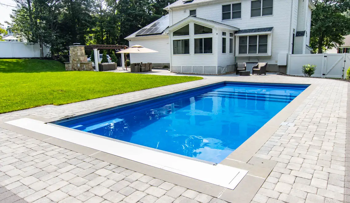 Leisure Pools Pinnacle inground fiberglass swimming pool with entry step in Silver Grey