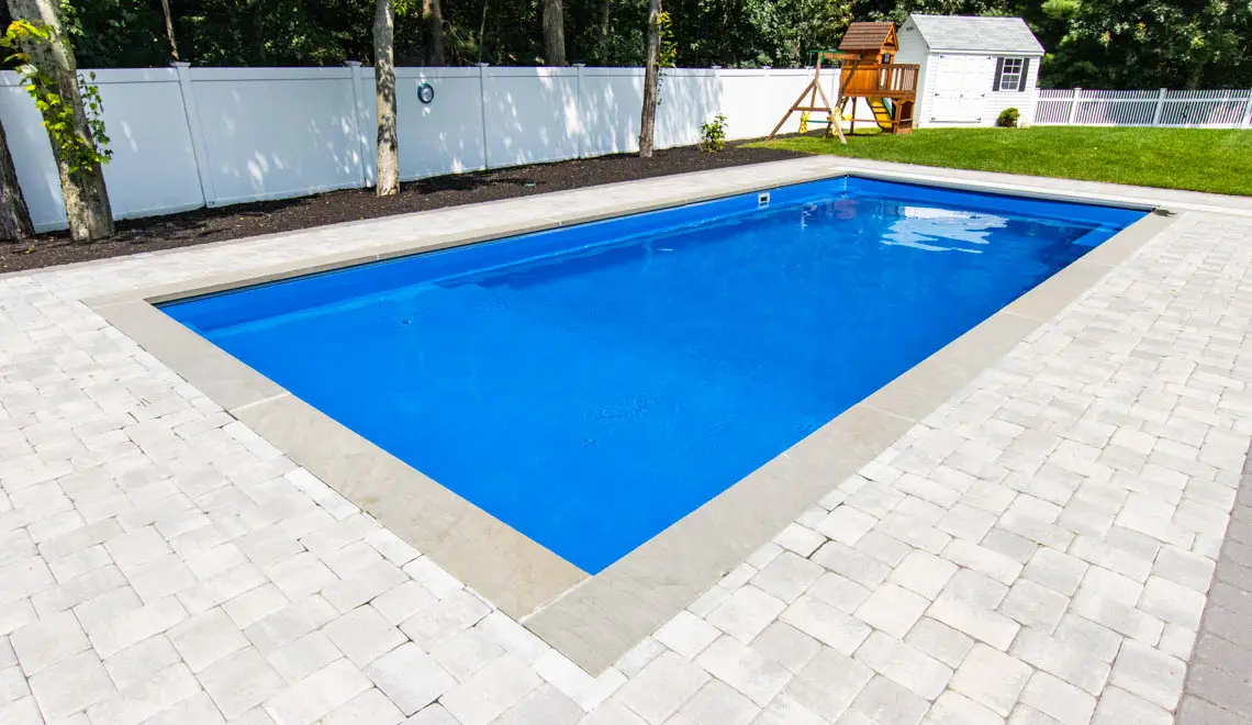 Leisure Pools Pinnacle inground fiberglass swimming pool with swim out benches in Silver Grey