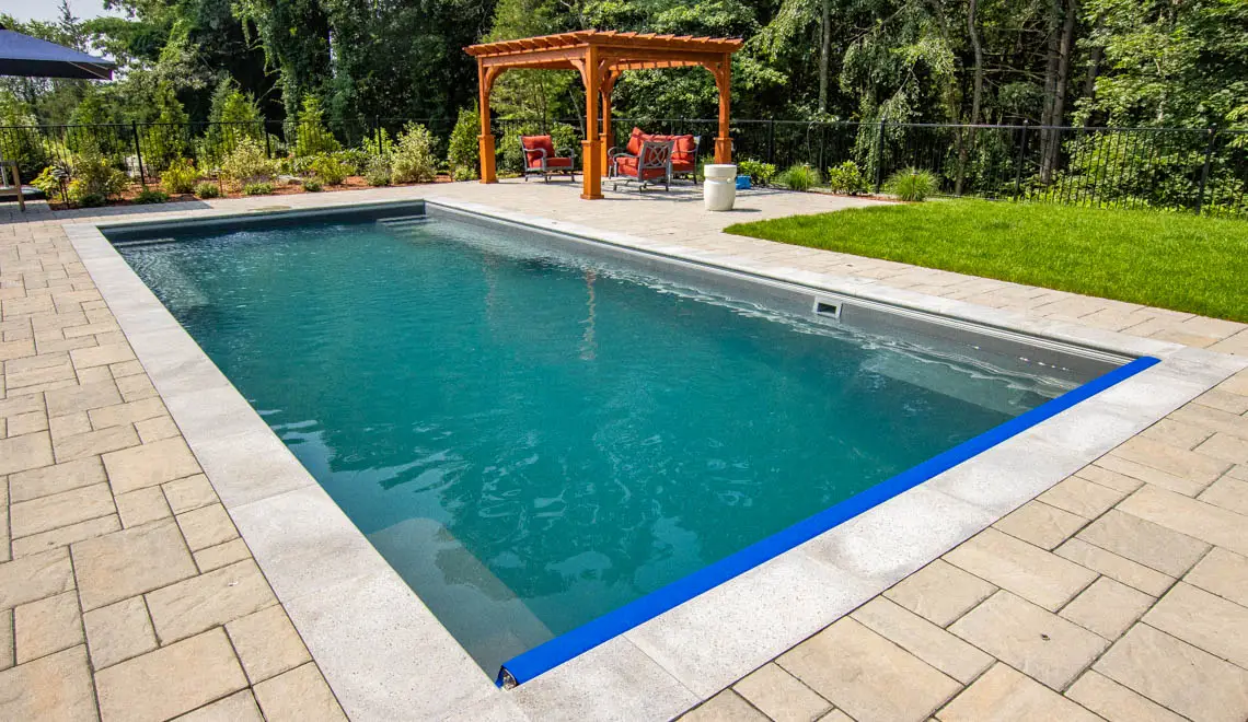 Leisure Pools Supreme inground fiberglass swimming pool with entry and exit steps in Graphite Grey