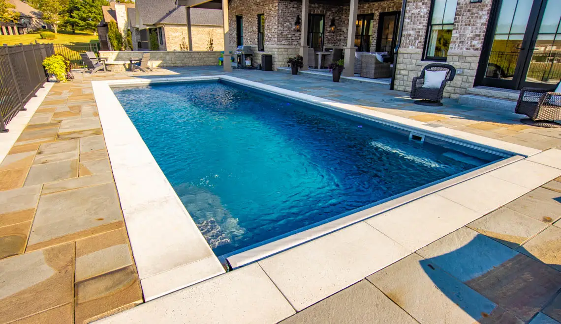 Leisure Pools Pinnacle composite fiberglass swimming pool with swim out benches in Silver Grey