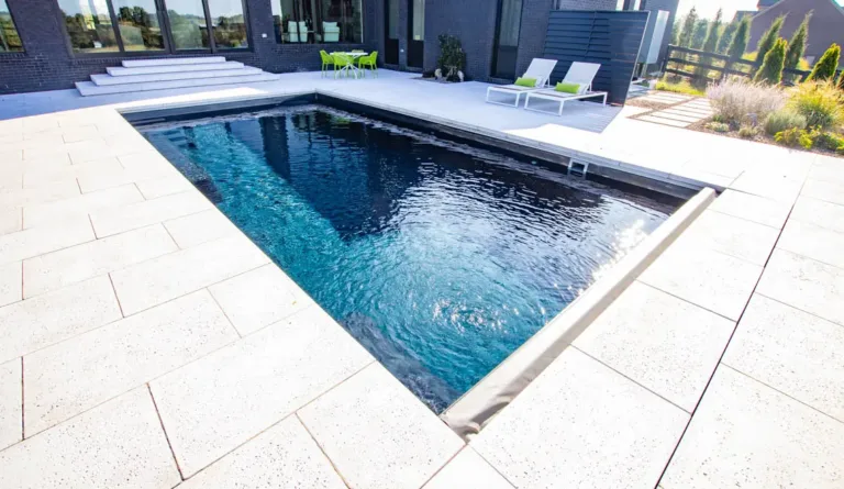 The Supreme 35 fiberglass pool in Graphite Grey with corner entry steps and open swim area
