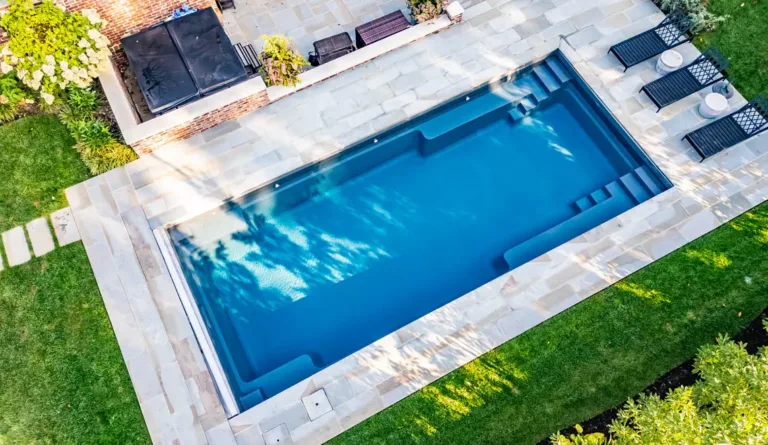 The Supreme 40 fiberglass pool in Graphite Grey with modern backyard patio installation