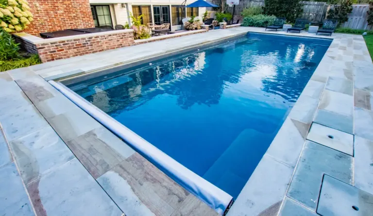 The Supreme 40 fiberglass pool generous bench seating and swim out ledges in Graphite Grey
