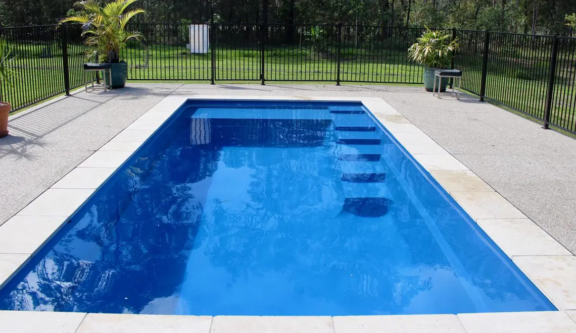 Leisure Pools Precision fiberglass flat bottom swimming pool with built-in splash deck